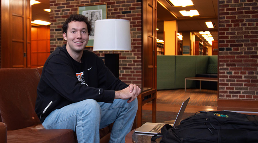 Student sitting on couch in front of laptop