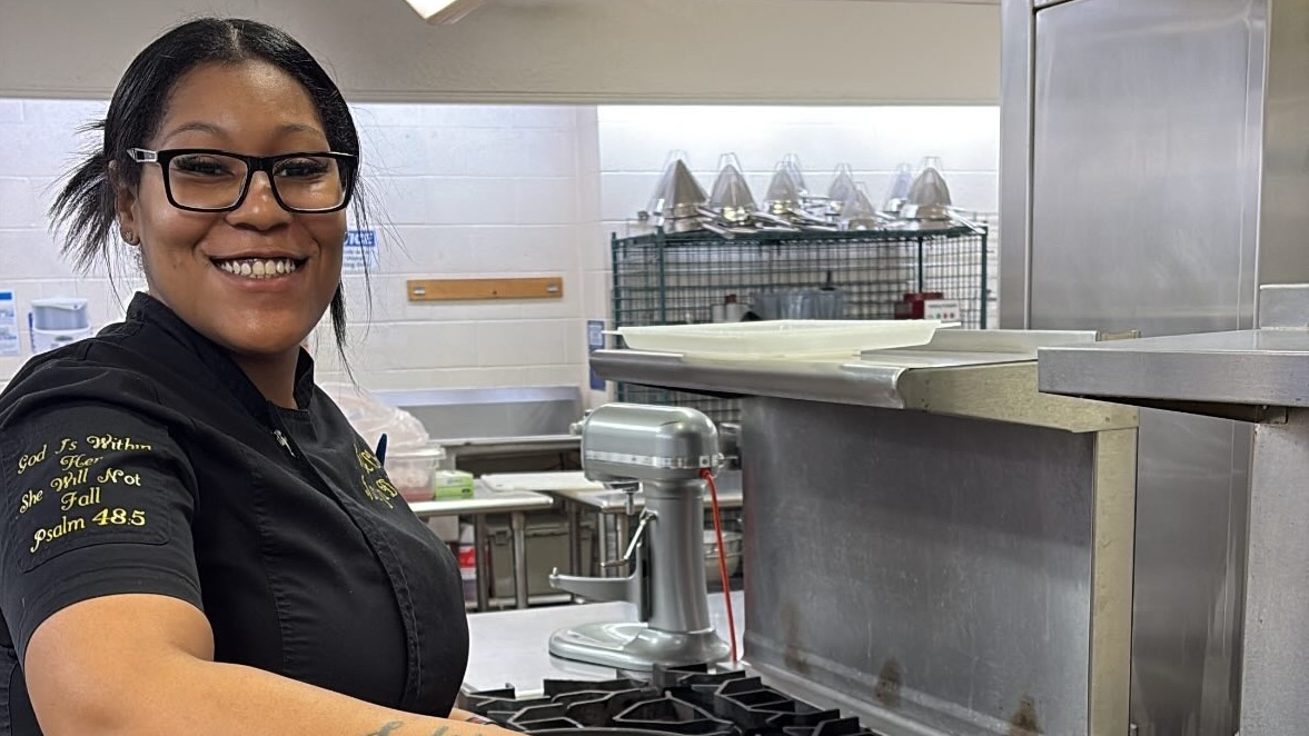 Janaja Harris smiles in the kitchen of her catering company, Fires Kitchen